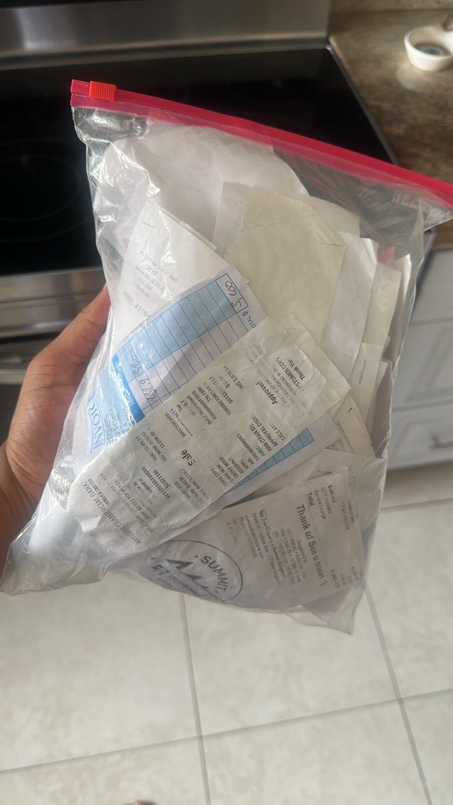 A freezer bag stuffed with crumpled Jamaican shop receipts and invoices
